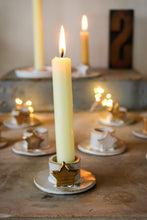 Load image into Gallery viewer, Gold and white stare stoneware candle holder. The star is gold. 
