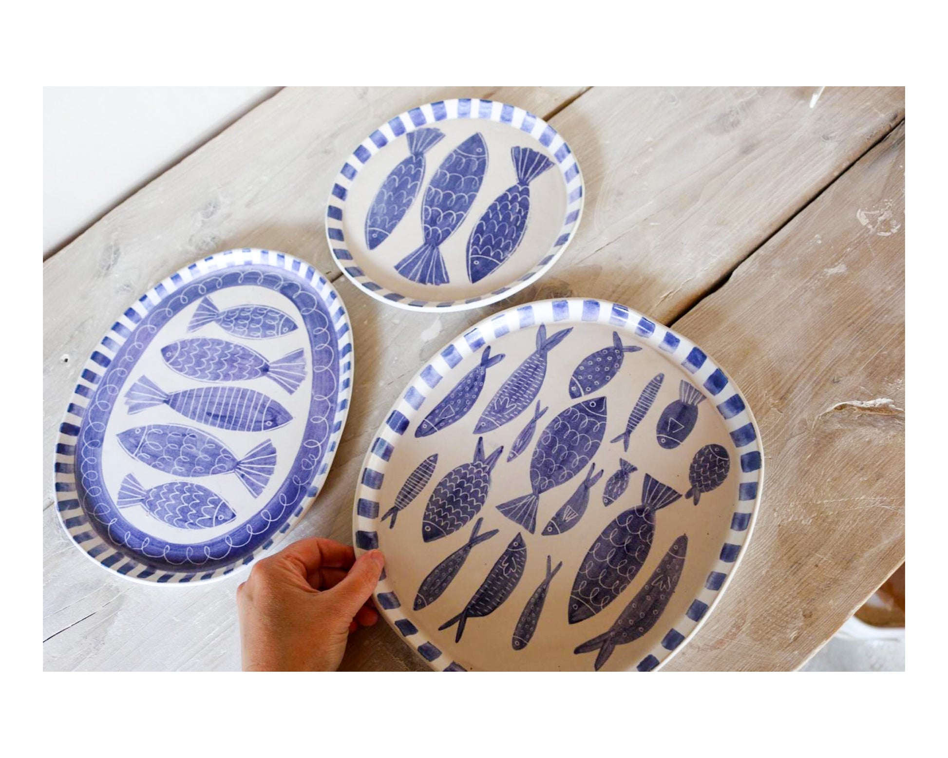 Laura Lane stoneware blue and white fishy plates varying sizes 